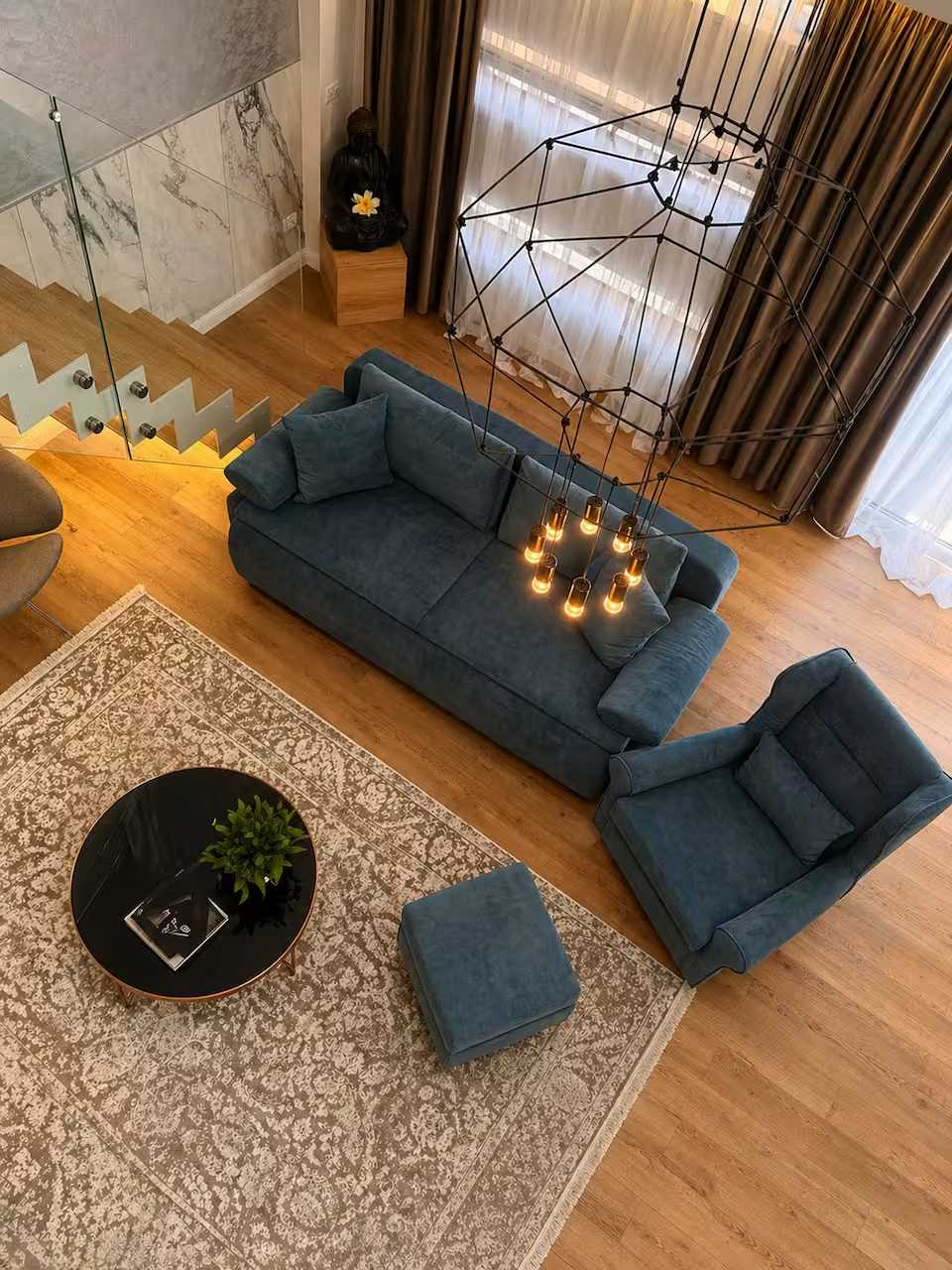 O cameră de zi cu canapea albastră și o masă — apartament în Oradea