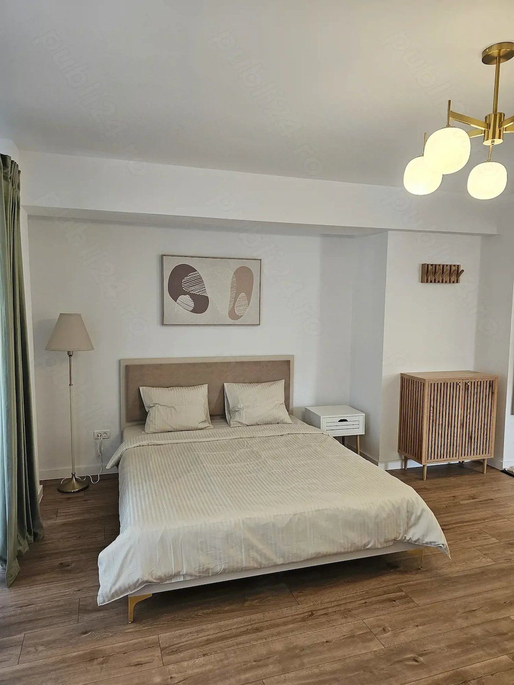 A bedroom with a bed and a lamp